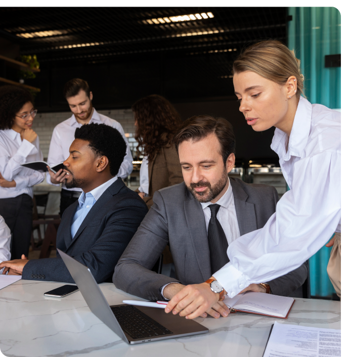 Professional team collaborating at a laptop, representing Bamshaw's work built for regulated federal contracting environments